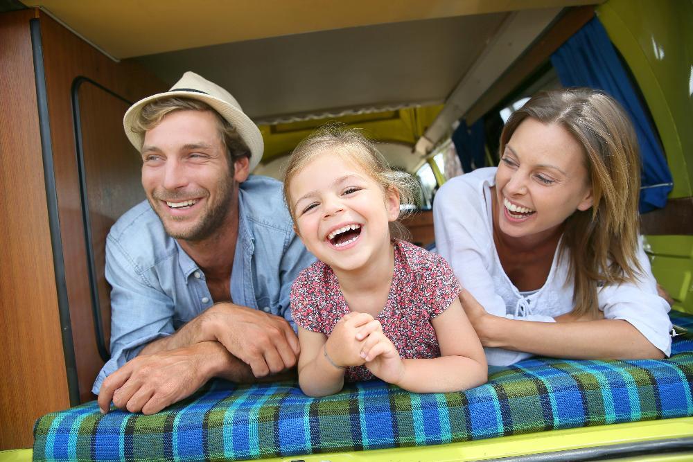 Father, daughter, and mother smiling 