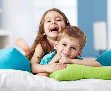 young brother and sister smiling