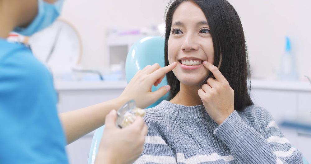 woman smiling during a dental cleaning