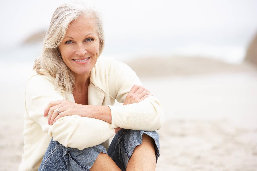 Older woman smiling on beach