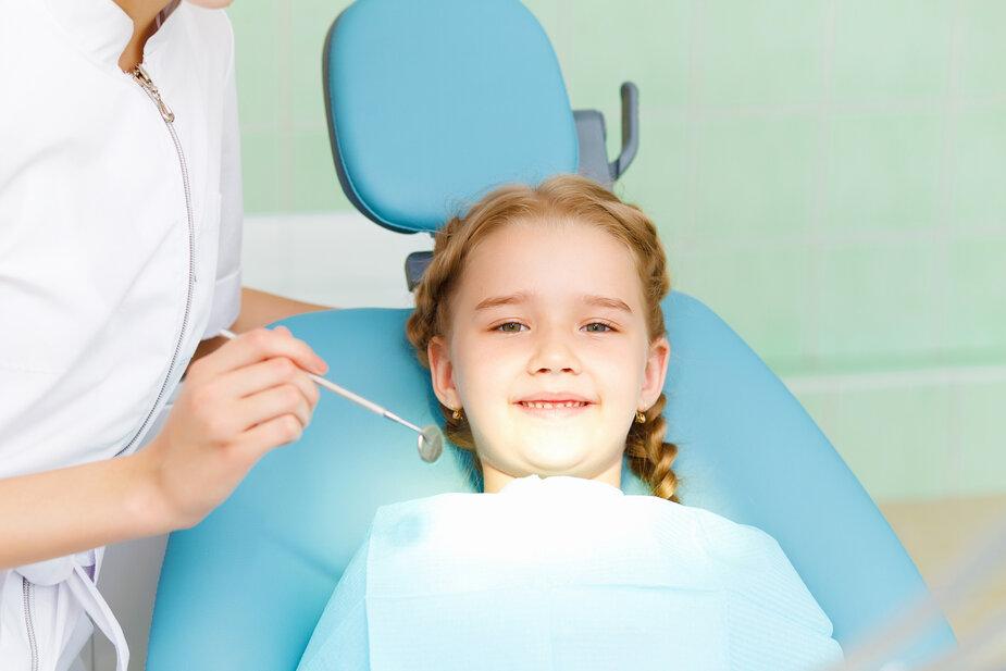 young girl sitting in a dental chair