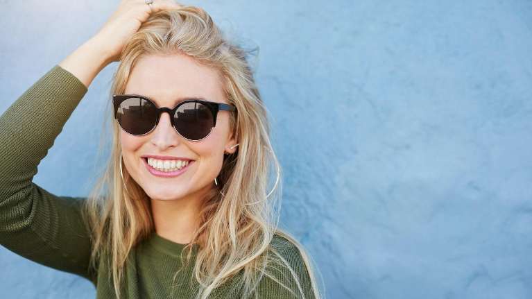 woman with sunglasses smiling in mirrabooka