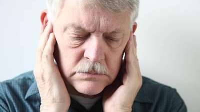 man holding jaw from pain from a gum infection