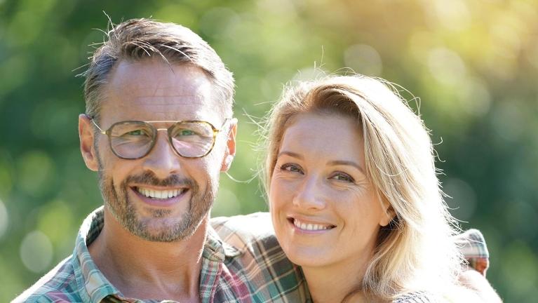 man and woman smiling while outside