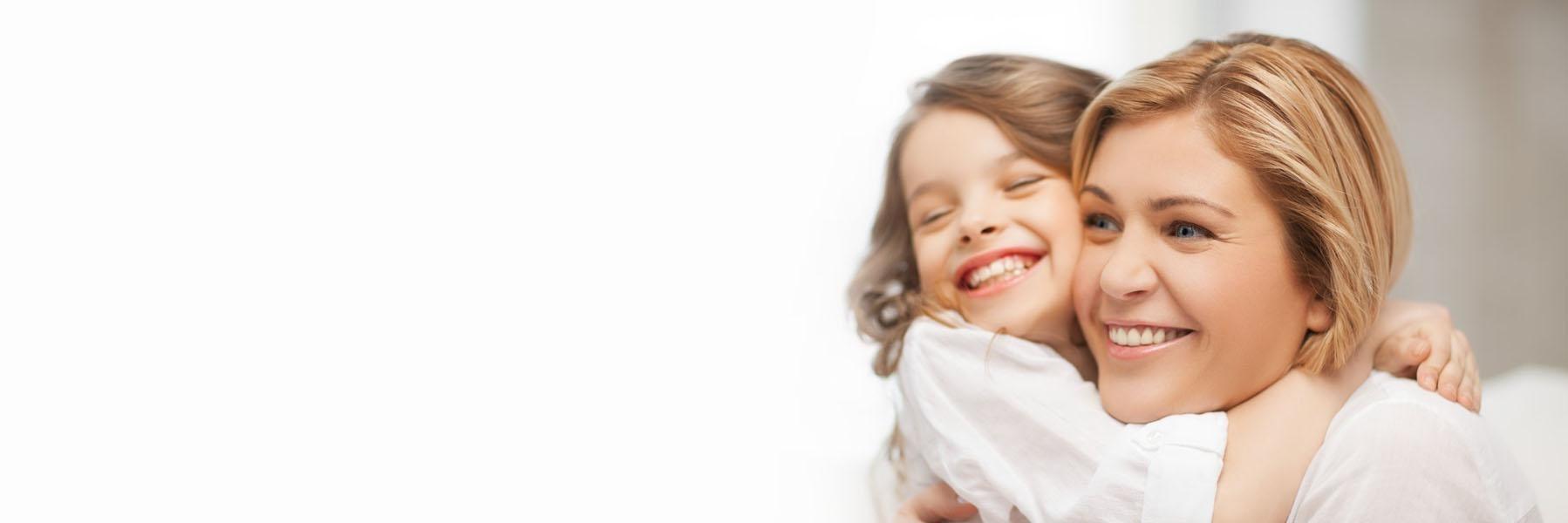 Young girl hugging her mom and smiling in mirrabooka