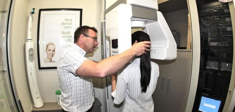 Dr Duke helping patient with dental xray